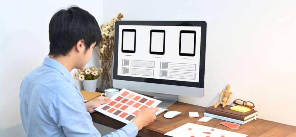 A Designer Is Selecting A Color While Sitt for Interactive Design
