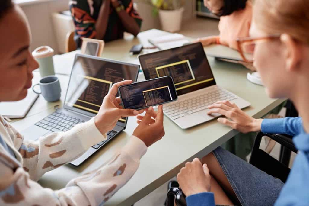 close-up-of-two-young-women-reviewing-code-on-smar