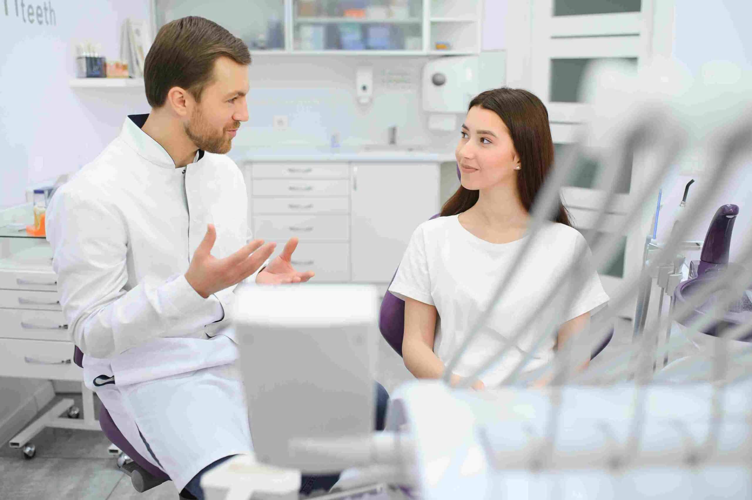 Dentist consulting with a smiling patient in a modern Irvine dental clinic